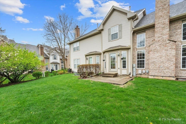 2097 Ivy Ridge Dr Unit 2097, Hoffman Estates, IL 60192 - rear view of house featuring a chimney, central air condition unit, a residential view, a patio area, and a lawn