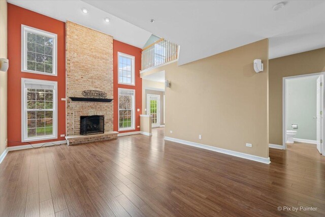 2097 Ivy Ridge Dr Unit 2097, Hoffman Estates, IL 60192 - unfurnished living room featuring baseboards, hardwood / wood-style flooring, and a towering ceiling