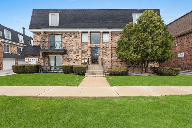 9830 Sayre Ave Unit 6, Chicago Ridge, IL 60415 - view of front of house with brick siding, a balcony, a shingled roof, and a front lawn