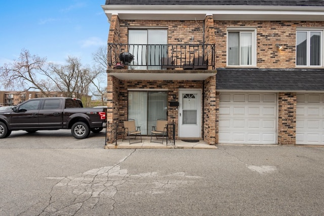 9830 Sayre Ave Unit 6, Chicago Ridge, IL 60415 - view of front of property featuring driveway, a balcony, brick siding, and a garage