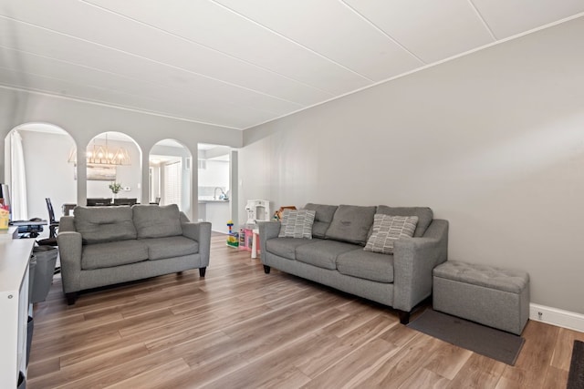 9830 Sayre Ave Unit 6, Chicago Ridge, IL 60415 - living room with a chandelier, light wood-type flooring, and arched walkways