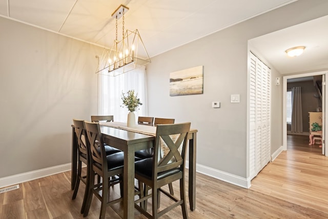 9830 Sayre Ave Unit 6, Chicago Ridge, IL 60415 - dining room with baseboards, visible vents, an inviting chandelier, and light wood-style flooring