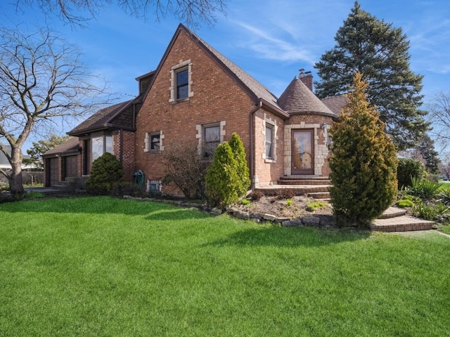 view of property exterior with a chimney, a lawn, and brick siding