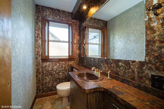 half bathroom featuring toilet and vanity