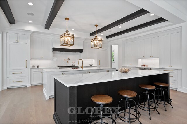 1544 Longvalley Rd, Glenview, IL 60025 - kitchen featuring a large island with sink, light wood-type flooring, backsplash, and beam ceiling