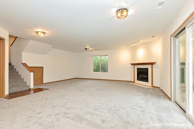 35850 N Benjamin Ave, Ingleside, IL 60041 - unfurnished living room featuring stairs, light colored carpet, a fireplace, baseboards, and rail lighting