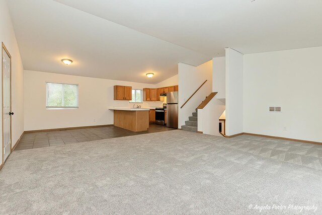 35850 N Benjamin Ave, Ingleside, IL 60041 - unfurnished living room featuring carpet flooring, lofted ceiling, stairway, baseboards, and a sink