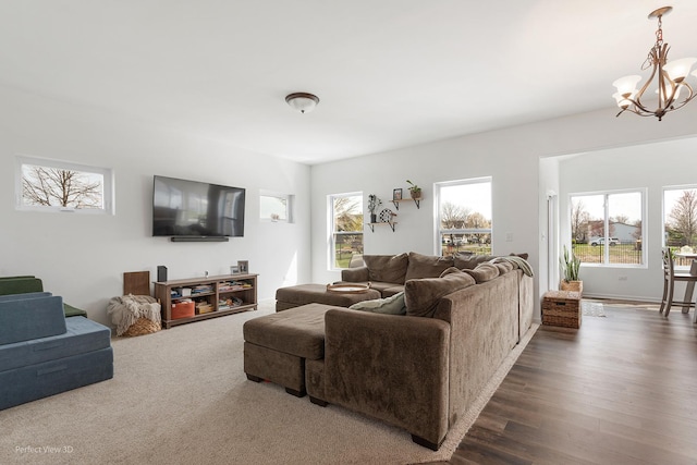 living room with a chandelier and dark wood-style flooring