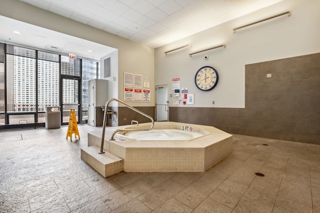 225 N Columbus Dr Unit 5305, Chicago, IL 60601 - bathroom with a high ceiling, tile patterned floors, tiled tub, and floor to ceiling windows