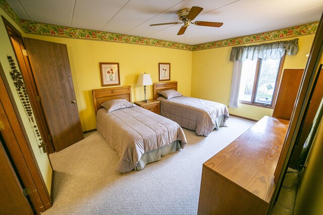 bedroom featuring a ceiling fan and carpet