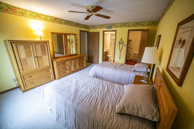 bedroom with visible vents, baseboards, a ceiling fan, ensuite bath, and carpet flooring