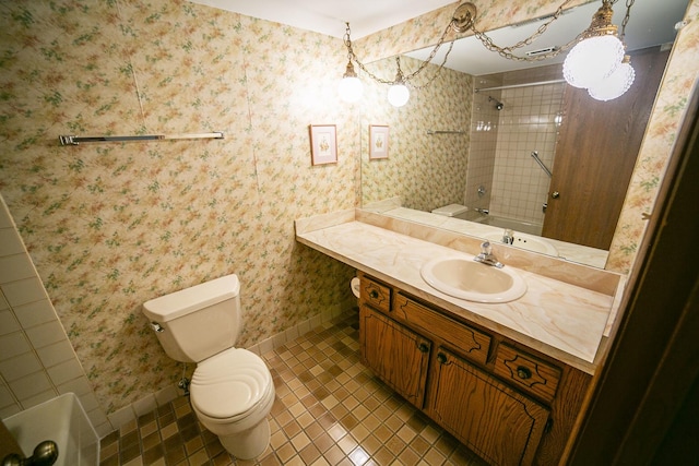 full bathroom with washtub / shower combination, vanity, baseboards, tile patterned floors, and toilet