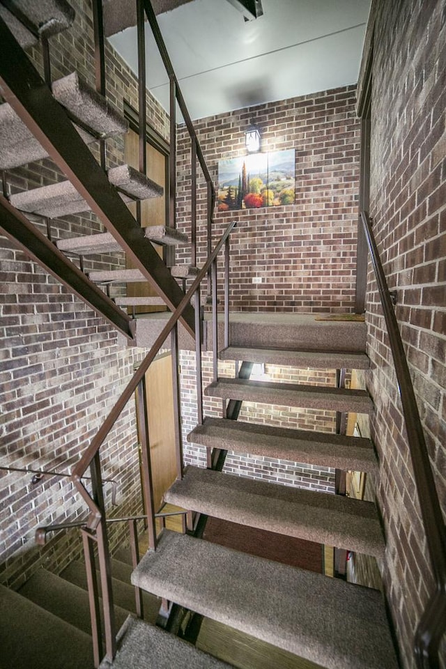stairs featuring brick wall