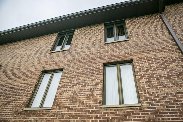 view of property exterior with brick siding