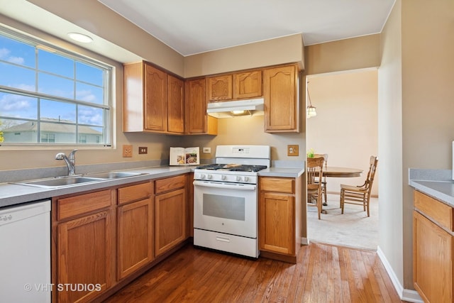 271 Valley Forge Ave, South Elgin, IL 60177 - kitchen with a sink, light countertops, under cabinet range hood, dark wood-type flooring, and white appliances