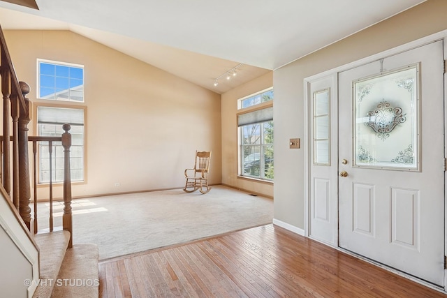 271 Valley Forge Ave, South Elgin, IL 60177 - carpeted foyer featuring hardwood / wood-style floors, stairway, vaulted ceiling, and baseboards