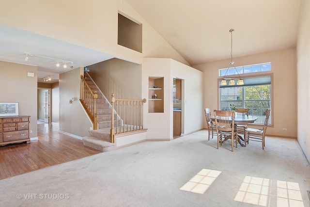 271 Valley Forge Ave, South Elgin, IL 60177 - carpeted dining space with a high ceiling, stairs, rail lighting, and baseboards