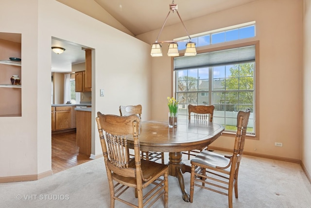 271 Valley Forge Ave, South Elgin, IL 60177 - dining space with baseboards, vaulted ceiling, light colored carpet, and plenty of natural light
