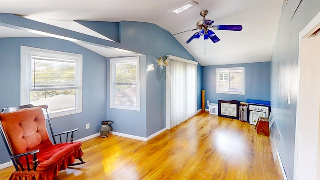 sitting room with wood finished floors, ceiling fan, baseboards, and lofted ceiling