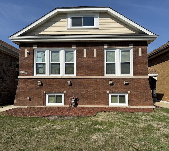 exterior space featuring a yard and brick siding