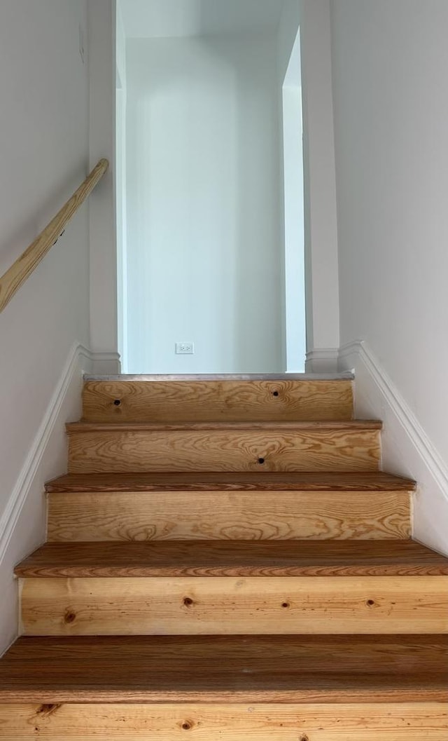staircase with wood finished floors
