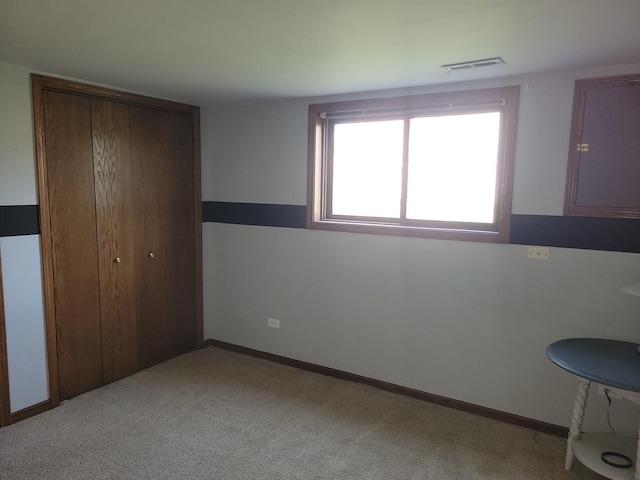 310 E Butler Ave, Grant Park, IL 60940 - unfurnished bedroom featuring a closet, carpet flooring, and visible vents
