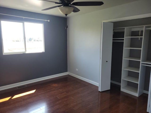 310 E Butler Ave, Grant Park, IL 60940 - unfurnished bedroom featuring ceiling fan, dark wood-type flooring, a closet, visible vents, and baseboards
