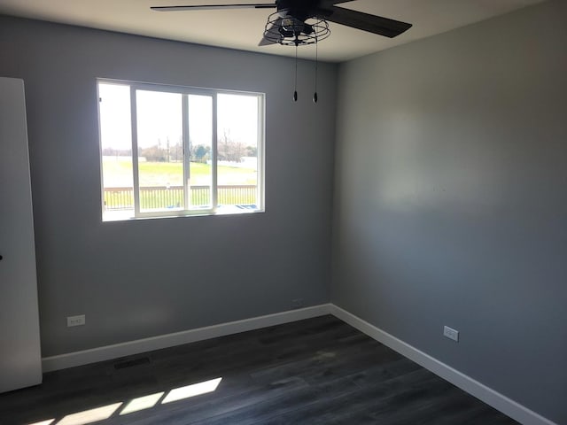 310 E Butler Ave, Grant Park, IL 60940 - unfurnished room featuring ceiling fan, baseboards, dark wood-style floors, and visible vents