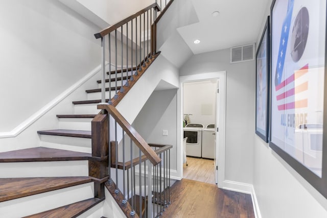 staircase featuring baseboards, recessed lighting, visible vents, washing machine and clothes dryer, and wood finished floors