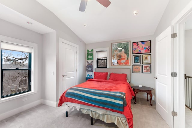 bedroom with baseboards, light colored carpet, ceiling fan, and lofted ceiling