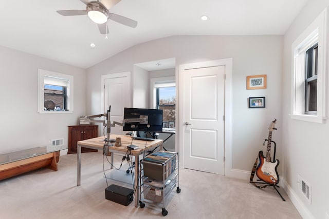 office with baseboards, visible vents, light colored carpet, and vaulted ceiling