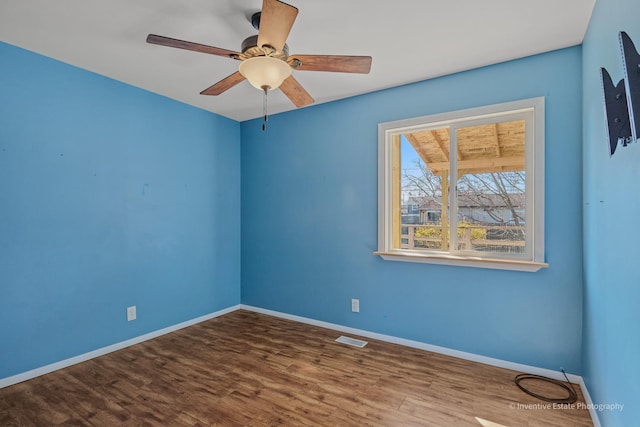 308 Eaton Ave, Romeoville, IL 60446 - unfurnished room with visible vents, baseboards, a ceiling fan, and wood finished floors