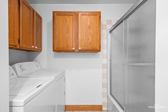 laundry area with washing machine and clothes dryer and cabinet space