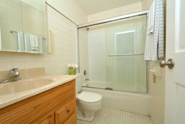 4731 Saint Joseph Creek Rd Unit 5G, Lisle, IL 60532 - full bath featuring tile walls, vanity, toilet, bath / shower combo with glass door, and tile patterned floors