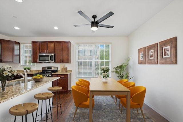 1529 E Arbor Ln, Arlington Heights, IL 60004 - kitchen featuring appliances with stainless steel finishes, a kitchen breakfast bar, dark wood-style flooring, plenty of natural light, and recessed lighting