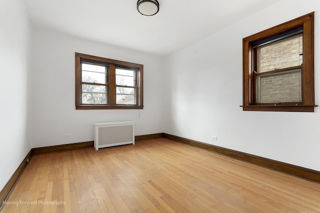 1916 Kenilworth Ave, Berwyn, IL 60402 - empty room featuring light wood-style flooring, radiator, and baseboards