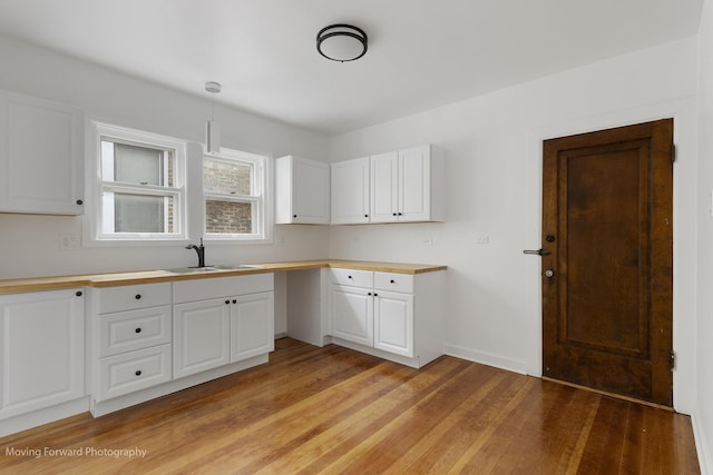 1916 Kenilworth Ave, Berwyn, IL 60402 - kitchen with a sink, light wood-style flooring, white cabinetry, and pendant lighting