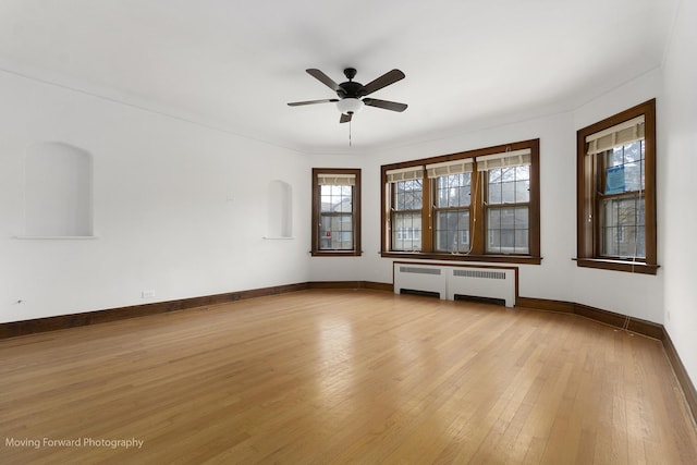 1916 Kenilworth Ave, Berwyn, IL 60402 - unfurnished room featuring light wood-style flooring, a ceiling fan, radiator, and baseboards