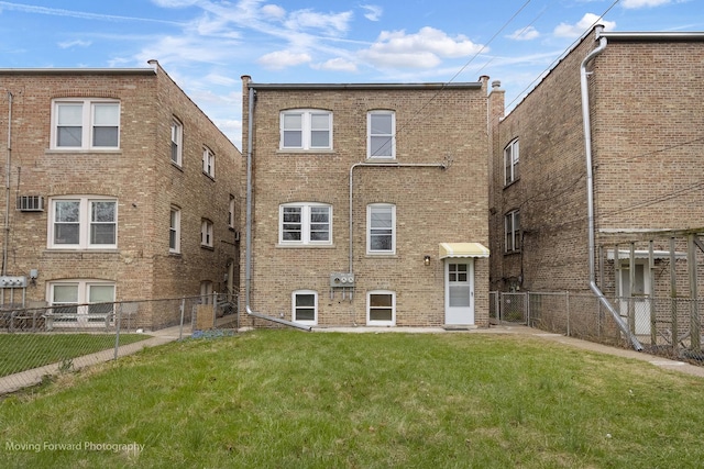 1916 Kenilworth Ave, Berwyn, IL 60402 - rear view of house featuring brick siding, a fenced backyard, and a lawn