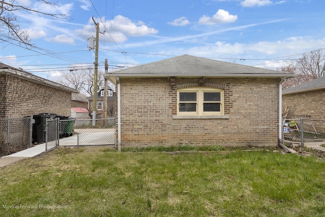 1916 Kenilworth Ave, Berwyn, IL 60402 - view of side of home with a gate, a lawn, brick siding, fence, and a shingled roof