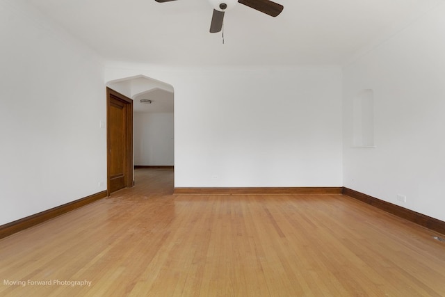 1916 Kenilworth Ave, Berwyn, IL 60402 - unfurnished room featuring baseboards, ornamental molding, a ceiling fan, light wood-style floors, and arched walkways
