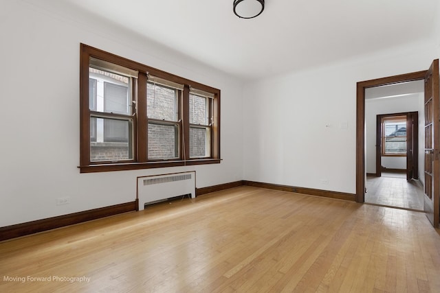 1916 Kenilworth Ave, Berwyn, IL 60402 - empty room with crown molding, radiator, light wood finished floors, and baseboards