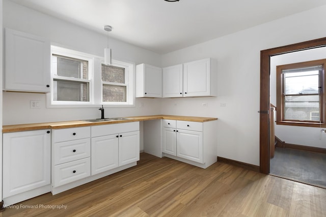 1916 Kenilworth Ave, Berwyn, IL 60402 - kitchen with butcher block counters, a healthy amount of sunlight, light wood finished floors, and a sink