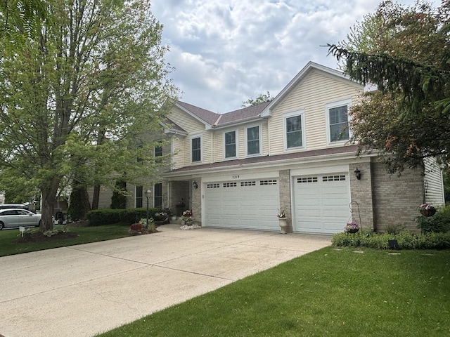 2219 Barrett Dr, Algonquin, IL 60102 - traditional home with concrete driveway, an attached garage, a front lawn, and brick siding