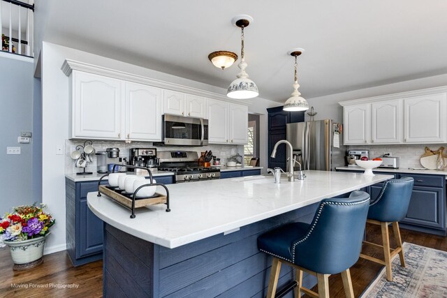 2219 Barrett Dr, Algonquin, IL 60102 - kitchen featuring appliances with stainless steel finishes, dark wood-style flooring, backsplash, and white cabinetry