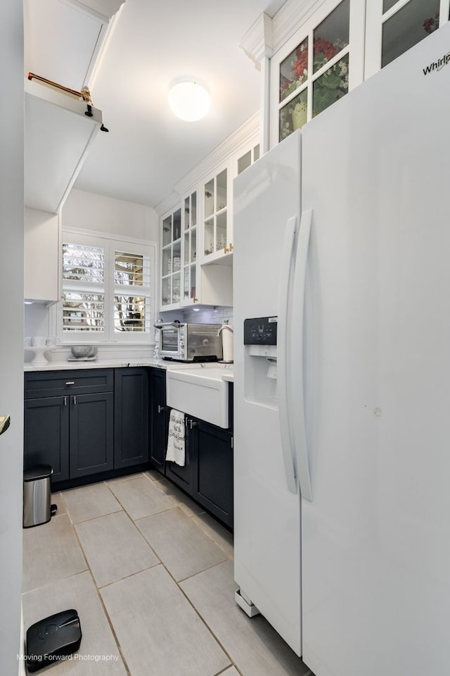 2219 Barrett Dr, Algonquin, IL 60102 - kitchen featuring white refrigerator with ice dispenser, light tile patterned floors, light countertops, glass insert cabinets, and white cabinets