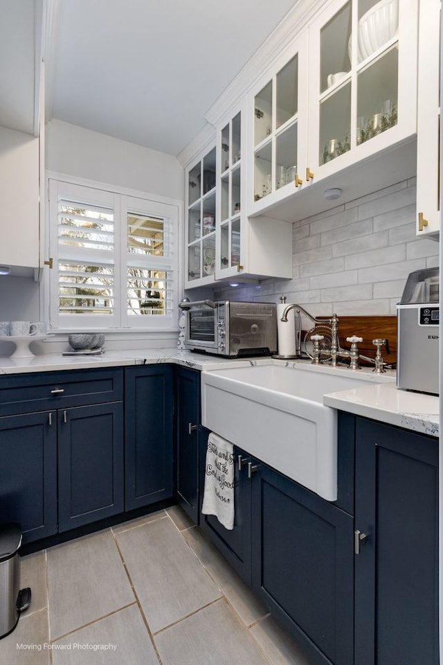 2219 Barrett Dr, Algonquin, IL 60102 - kitchen with blue cabinetry, tasteful backsplash, glass insert cabinets, and white cabinets