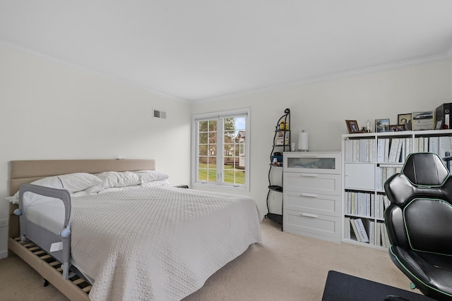 carpeted bedroom featuring visible vents and ornamental molding