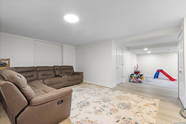 living area featuring baseboards and light wood finished floors