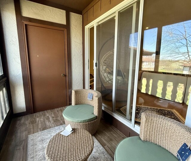 9748 Mill Dr E Unit 2E, Palos Park, IL 60464 - sunroom / solarium with wood finished floors and a textured wall